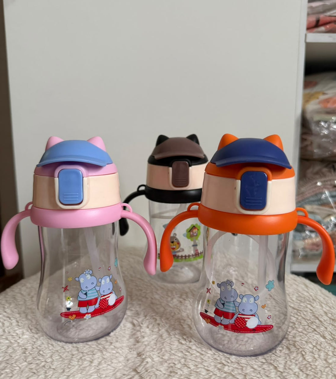Colorful toddler sippy cups with handles