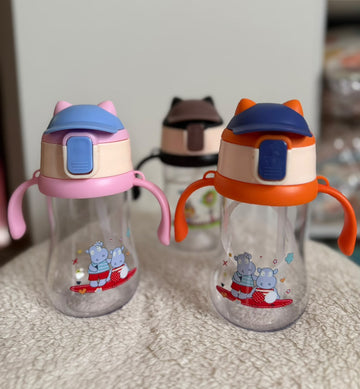 Colorful toddler sippy cups with handles